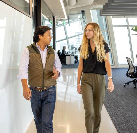 Two Amherst team members walking through office